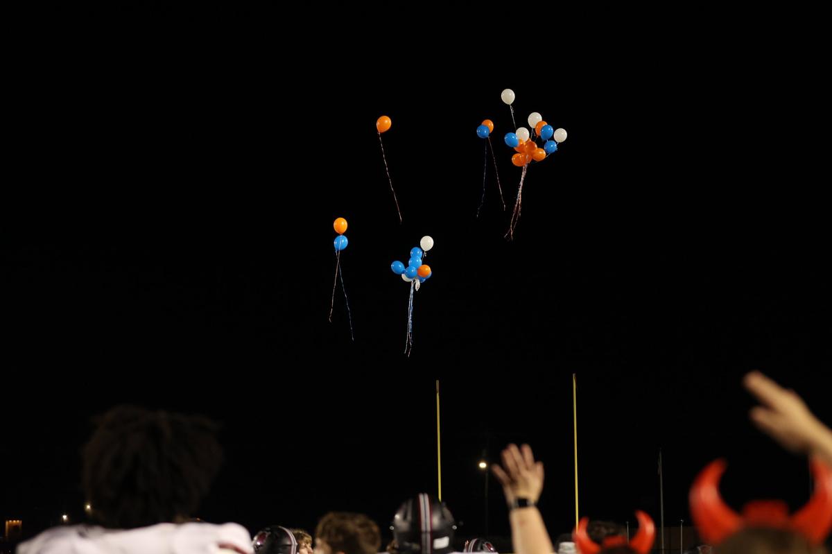 Warner Robins High School cheerleaders release orange and blue balloons at the end of the game during the football game between Warner Robins and Northside High Schools on Friday, Aug. 30, 2024, at McConnell Talbert Stadium in Warner Robins, Georgia. The Warner Robins High School football team defeated the Northside High School team 34-12.