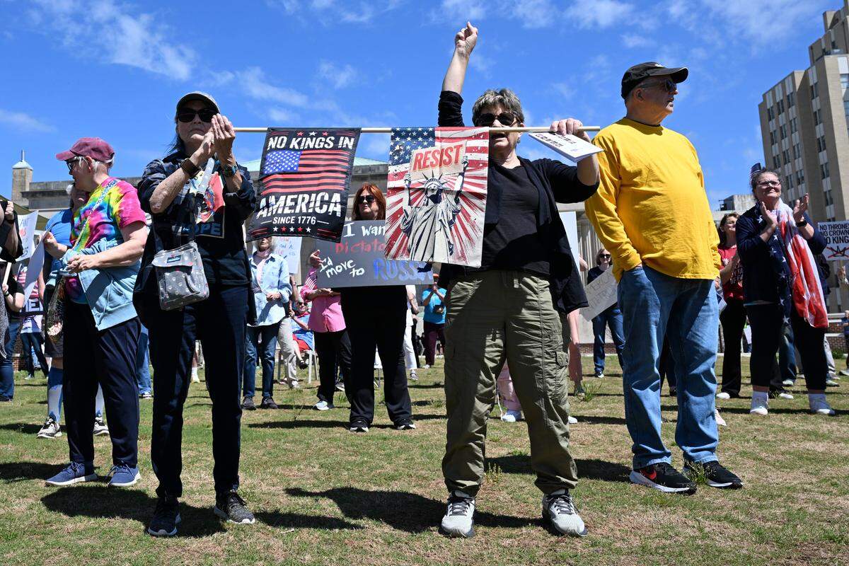 Laura Corkery, from Dublin, Georgia, (right) raises her fist during the No Kings Protest at Rosa Parks Square in Macon, Ga., March 28, 2026. Several hundred attendees gathered in the park as part of a national day of protest against President Donald Trump’s administration. Speakers encouraged peaceful civic engagement.