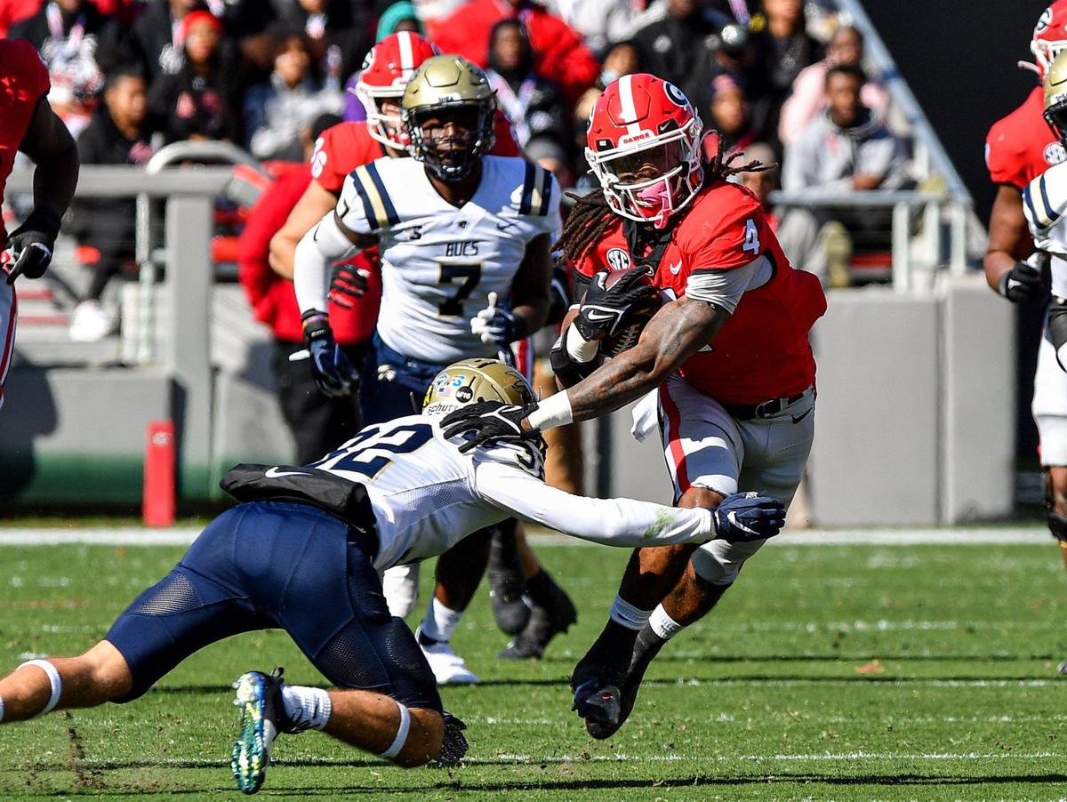 Georgia running back James Cook slips a tackle and heads for a first down against Charleston Southern Saturday in Athens.