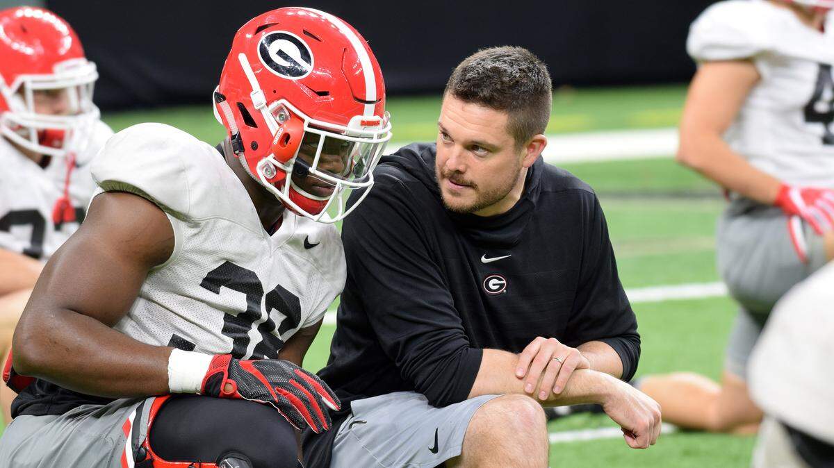 Georgia outside linebackers coach Dan Lanning confers with outside linebacker Robert Beal (33) during a practice in the Mercedes-Benz Superdome in New Orleans, La., on Saturday, Dec. 29, 2018. The Bulldogs will face Texas on Jan. 1, 2019, in the Allstate Sugar Bowl. (Photo by Steven Colquitt)