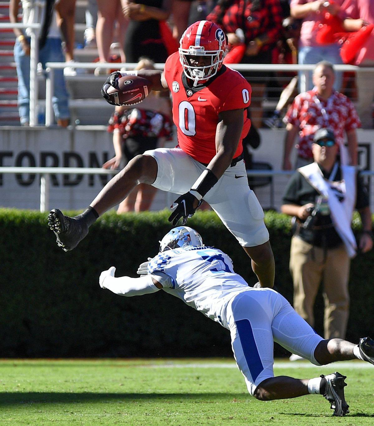 DONN RODENROTH,Athens, Georgia, 10/16/2021: Georgia Bulldog Darnell Washington hurdles a Kentucky defender in first half action Saturday in Athens.