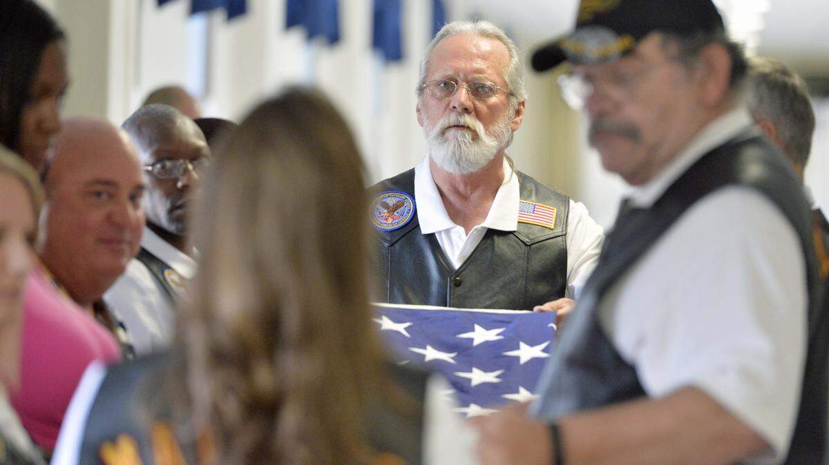 Les Black helps fold an American flag after an honor escort exercise at the Carl Vinson VA Medical Center in Dublin in June 2015.