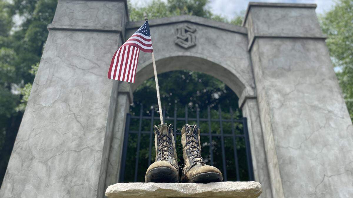 A pair of boots and an American flag are placed at the entrance of of the Stanislaus neighborhood in Macon every year around Memorial Day and Veterans Day. The boots are from Jack Cartwright, and then honor five of his high school friends who died in Vietnam.