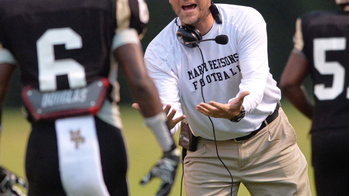 EVAN RODENROTH/For The TELEGRAPH,Forsyth, Georgia, 08/28/2015: Mary Persons Head Coach Brian Nelson congratulates Roger Akin as he returns to the sidelines after a Mary Persons touchdown in their match-up against Jackson High School.