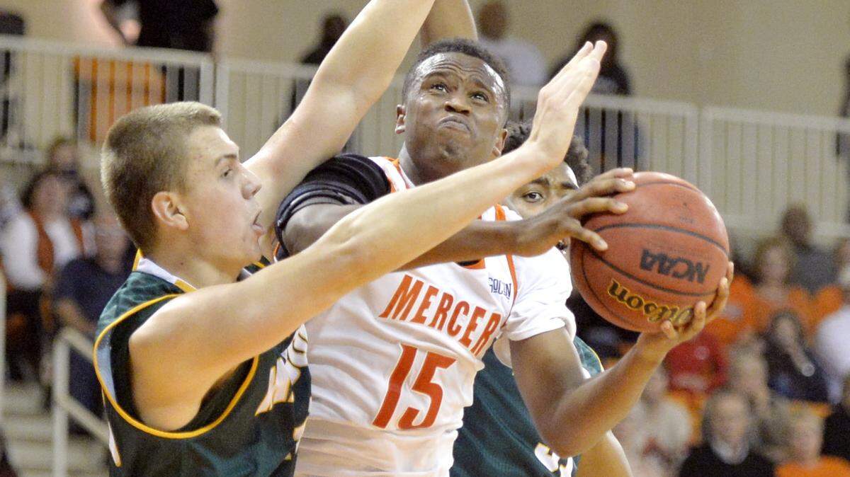 JASON VORHEES/THE TELEGRAPH Macon, GA, 11/16/2015: 
 Mercer forward Stephon Jelks (15) is fouled while attempting a shot under the basket during their game against George Mason Monday night.