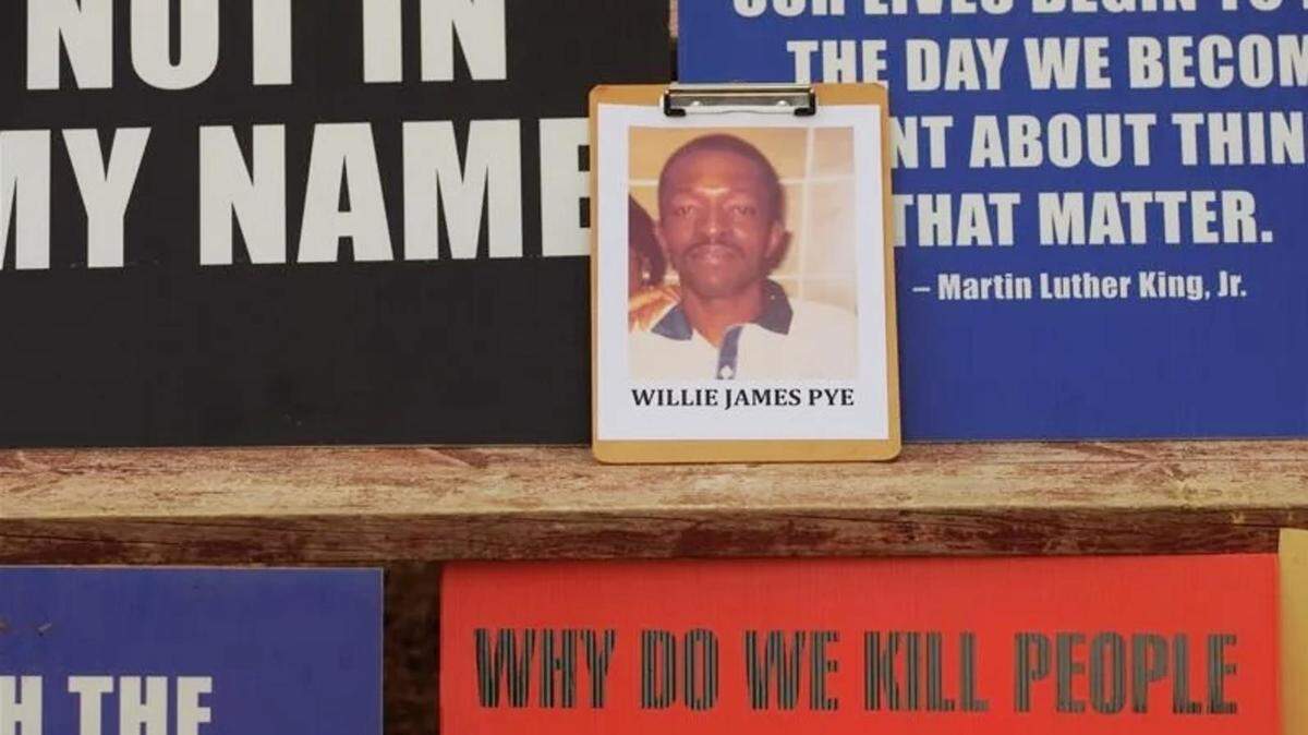 A photo of Willie Pye among the posters of death penalty opponents outside Georgia Diagnostic Prison during Pye’s execution.