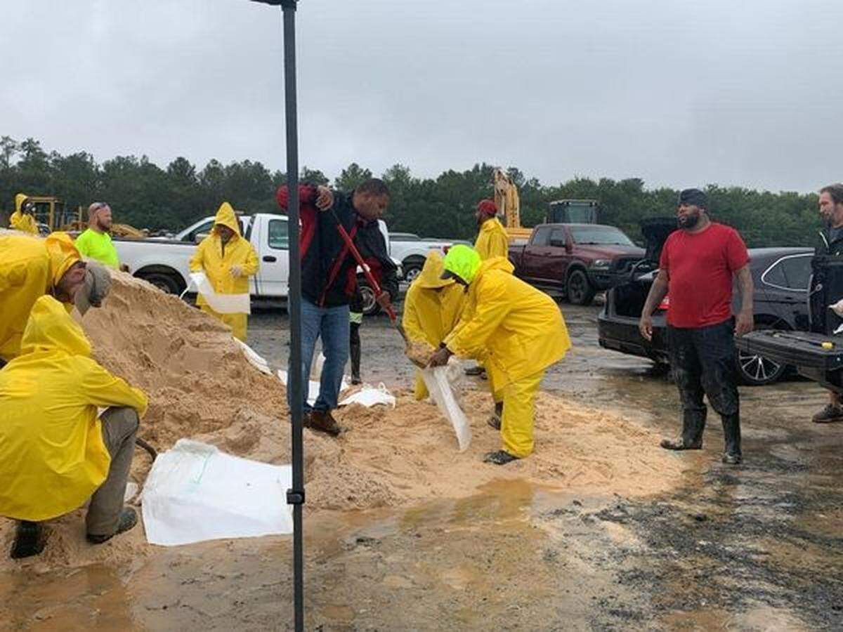 Warner Robins city staff help residents fill and load sandbags Thursday in preparation for Hurricane Helene.