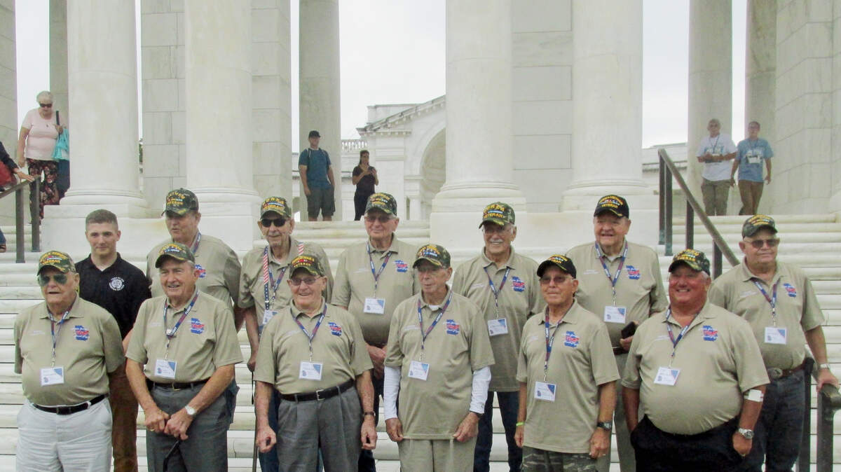 War veterans from Middle Georgia pose for a photo with Cameron Payne, back left, an honor guard at the Tomb of the Unknown Soldier,  after the group visited the tomb on Sept. 8. It was part of a free tour of Washington war monuments arranged by the newly formed Middle Georgia Honor Flight.