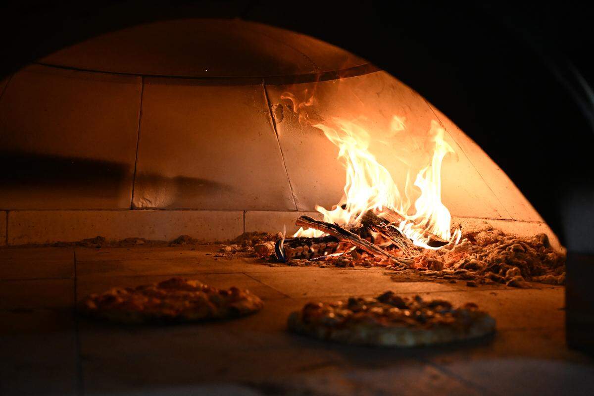 Pizzas cook inside the wood-fired oven at the new Smokin’ Oak Wood-Fired Pizza and Taproom in Warner Robins. The wood-fired oven uses 12 month aged oak and can cook pizzas in 90 seconds to two minutes.