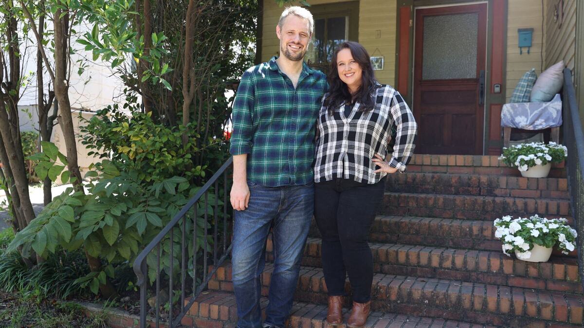 Lynsey Free (right) and her husband pose in front of their house on Saturday, Aug. 24, 2024, in Macon, Georgia. Free moved to Macon in 2020 from Italy, but originally planned on moving back to Atlanta.