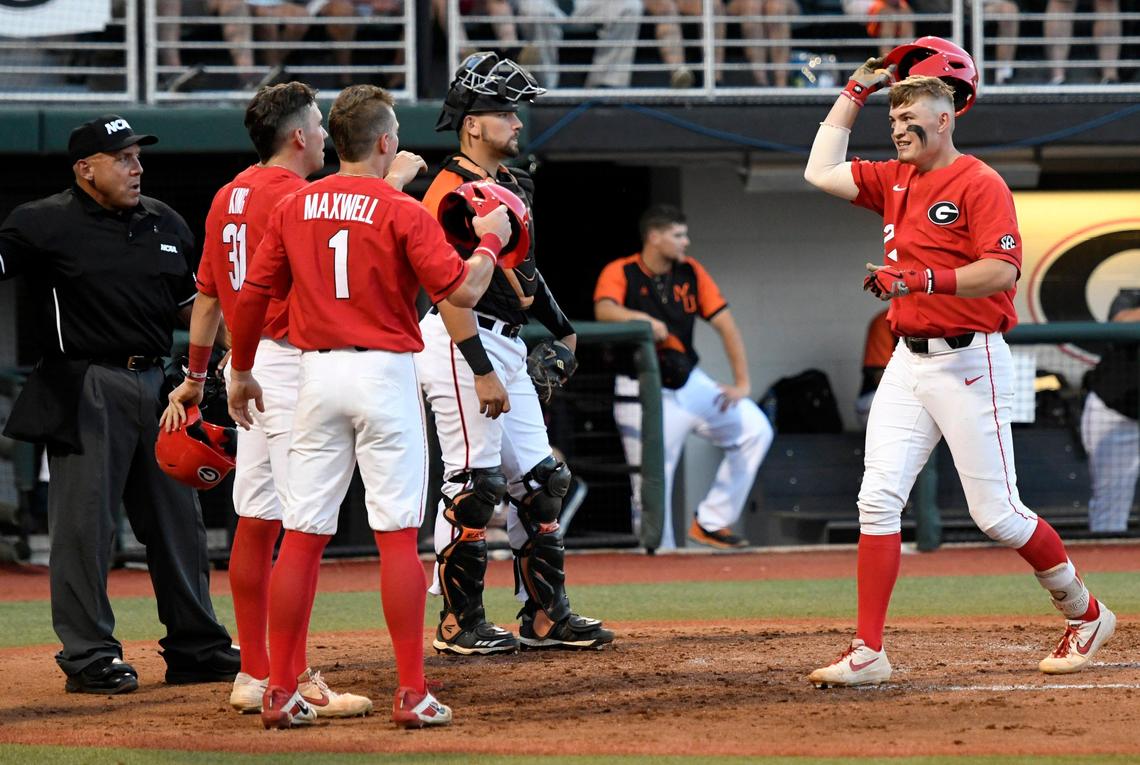 Georgia’s Aaron Schunk (22) gets congratulated by teammates after his second home run during the Bulldogs NCAA regional game against Mercer Friday night.