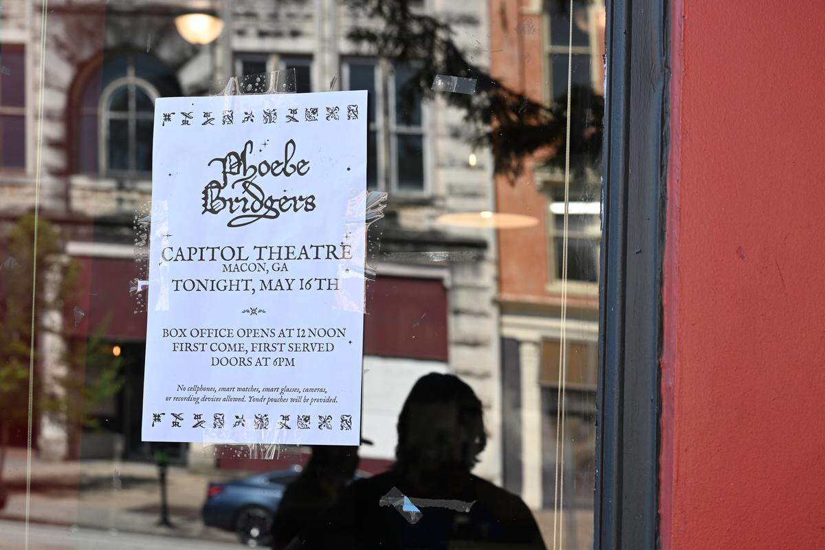 A poster hangs in the window at Fatty’s Pizza for Phoebe Bridgers’ pop-up concert at Robins Financial Capitol Theatre on Saturday, May 16, 2026, in Macon, Georgia. 