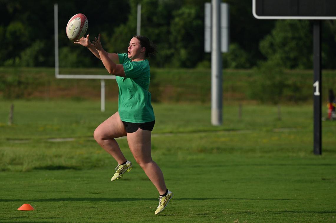 Margaret Peth jumps to catch the ball during drills at Macon Love Rugby practice on Thursday, Aug. 8, 2024, at Central City Park in Macon, Georgia. Macon’s amateur rugby team is expanding their team by competing with an all-female team at a summer competition this weekend.