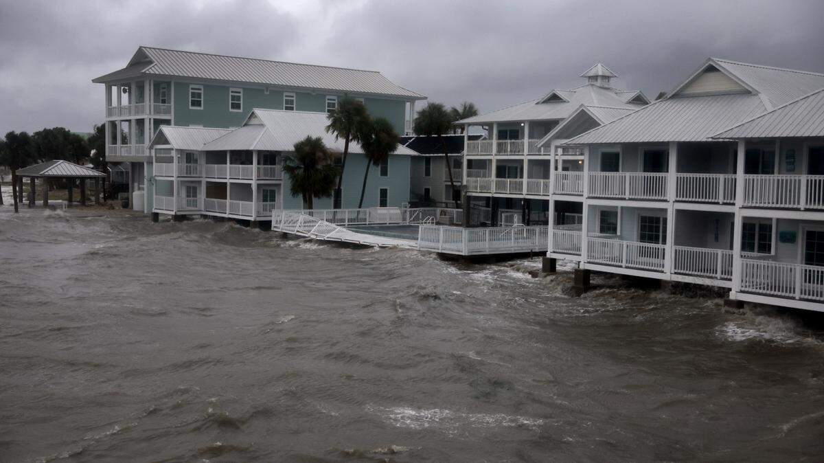 Buildings sit along the coast line as the rain and storm surge from Hurricane Debby inundate a neighborhood Monday in Cedar Key, Florida.