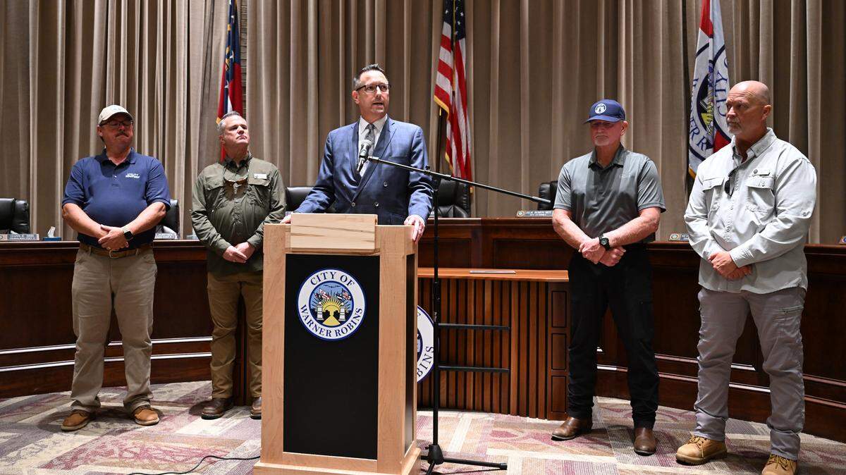 City of Warner Robins city administrator James Drinkard (middle) speaks at a press conference with representatives from Utilities, Public Works, Stormwater and the Georgia Department of Transportation (GDOT) on the status of a water main break on Thursday, Aug. 21, 2025, at City Hall in Warner Robins, Georgia. City officials aim to restore water to around 700 customers that have had no water since Tuesday afternoon by 8 p.m. tonight after a water main break on Watson Boulevard. 