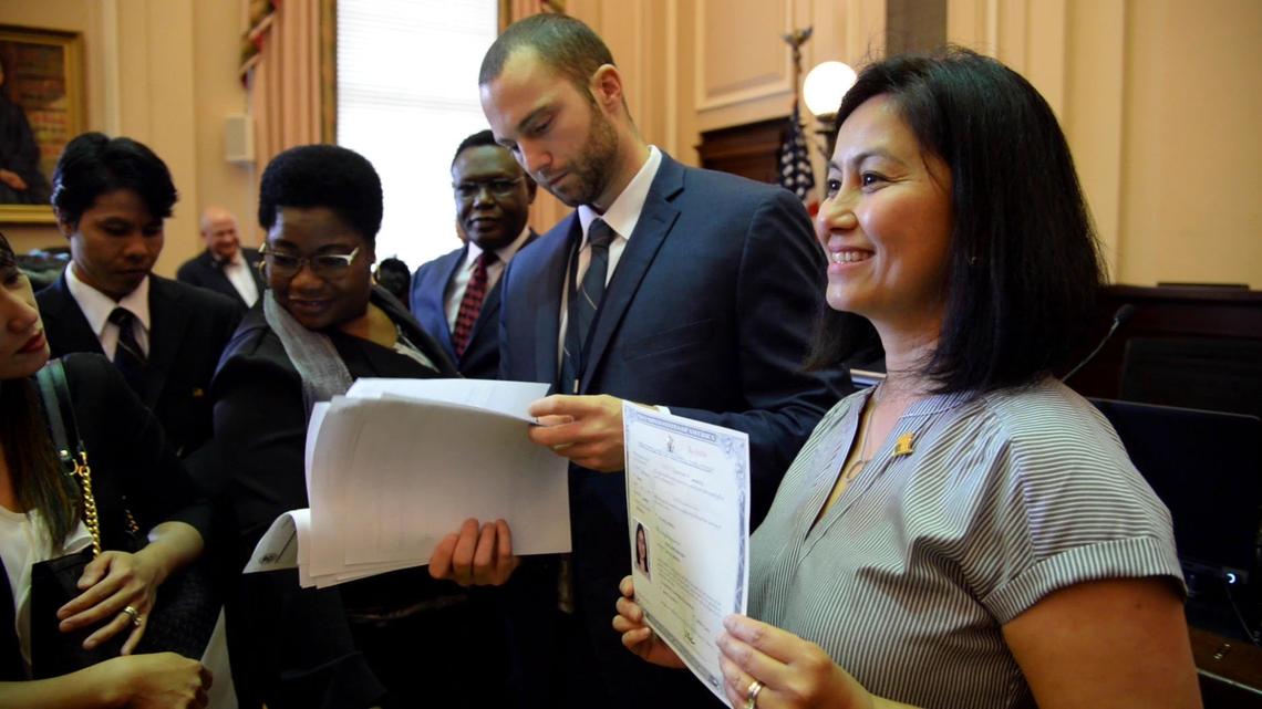 JENNA EASON/THE TELEGRAPH Macon, GA, 04/17/2019: Fern Bain, right, holds up her Certificate of Naturalization for a photograph after her naturalization ceremony in the William Augustus Bootle Federal Building and U.S. Courthouse on Wednesday, April 17, 2019.