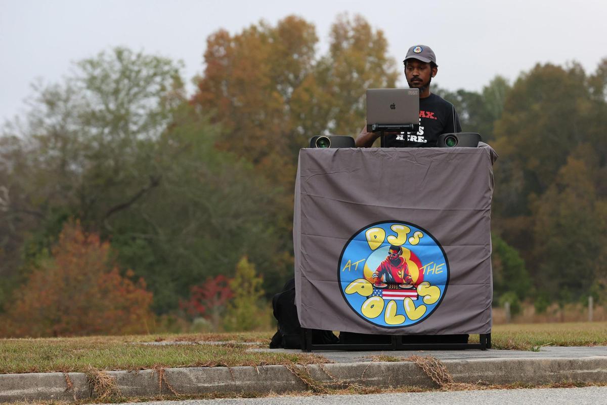 Junior Plaisir, who goes by the name DJ Rico, begins playing music outside of the polling location at Macon Evangelistic Church on Election Day on Tuesday, Nov. 5, 2024, in Macon, Georgia. Plaisir plans to travel to different polling locations in Macon to DJ throughout the day as a part of a national initiative called “DJs at the Polls.”