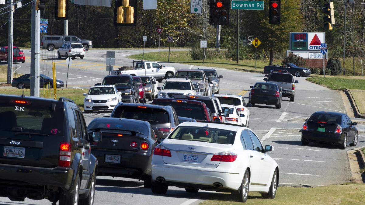 A driver in lunchtime traffic at the Bass Road/Bowman Road intersection drives off the pavement to get into the right turn lane Friday. The Macon-Bibb County Commission could vote Tuesday on funding for about $2 million in road projects. Among the projects is $145,000 for engineering concepts as part of a 5-mile project on Bass Road between Riverside Drive and Zebulon Road. The majority of the costs for the projects will come from the state Department of Transportation.