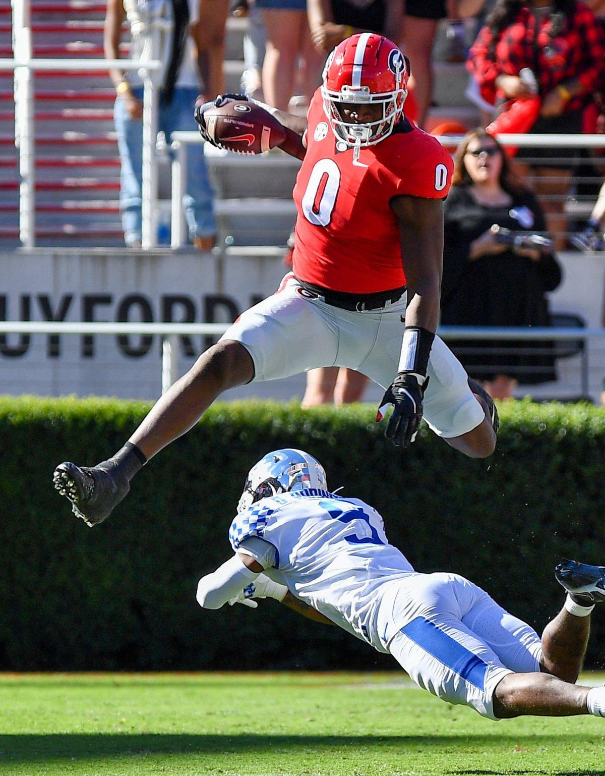 DONN RODENROTH,Athens, Georgia, 10/16/2021: Georgia Bulldog Darnell Washington hurdles a Kentucky defender in first half action Saturday in Athens.