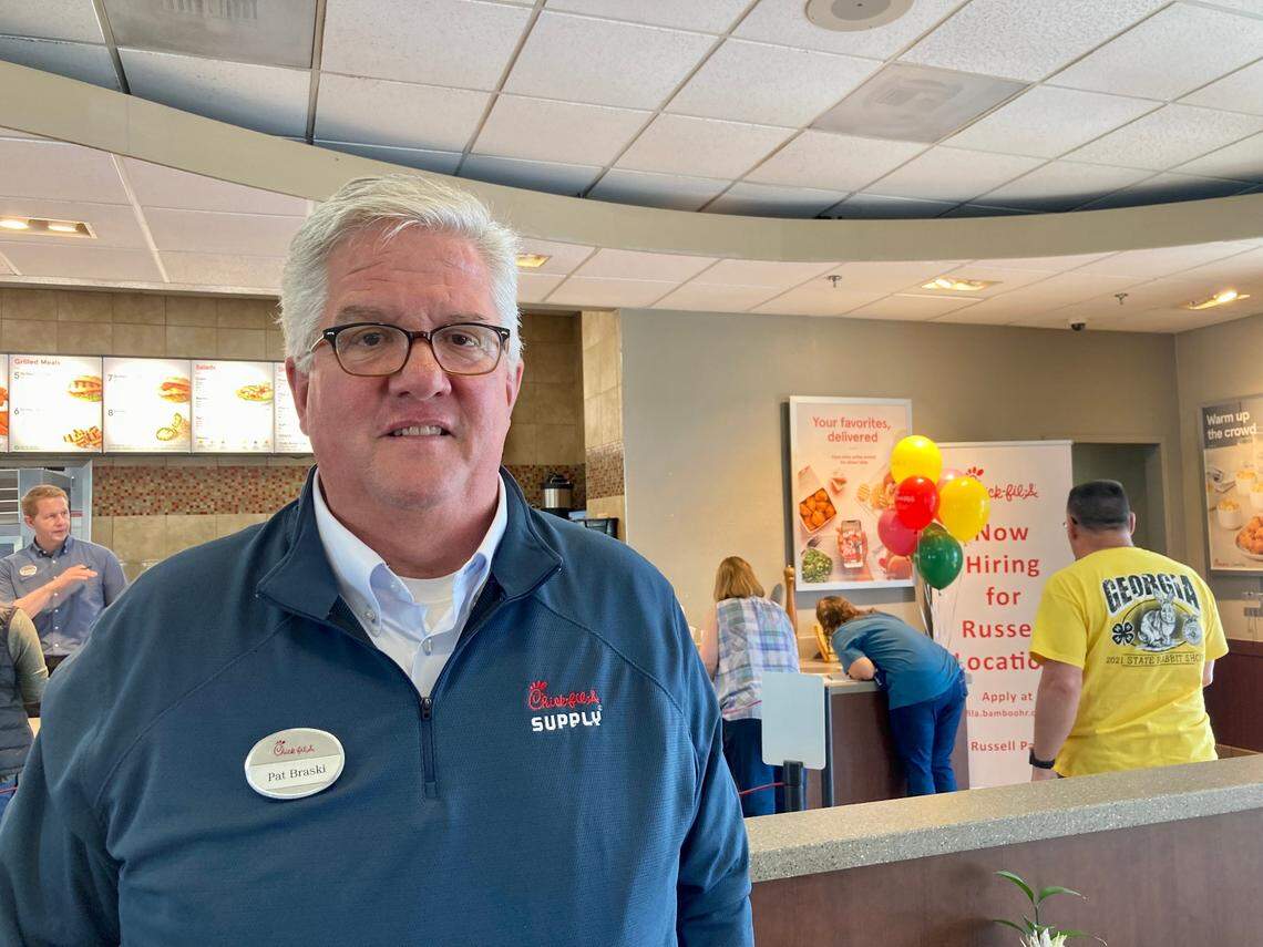Chick-fil-A owner and operator Pat Braski at the “last bite” at the restaurant at 1867 Watson Blvd. the day before it closed Friday. The restaurant’s new location at 621 Russell Parkway opens Thursday. A woman in the background writes a note on white paper left on a counter near a scrapbook for customers and employees to share thoughts, memories and best wishes.