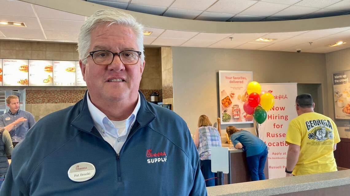 Chick-fil-A owner and operator Pat Braski at the “last bite” at the restaurant at 1867 Watson Blvd. the day before it closed Friday. The restaurant’s new location at 621 Russell Parkway opens Thursday. A woman in the background writes a note on white paper left on a counter near a scrapbook for customers and employees to share thoughts, memories and best wishes.