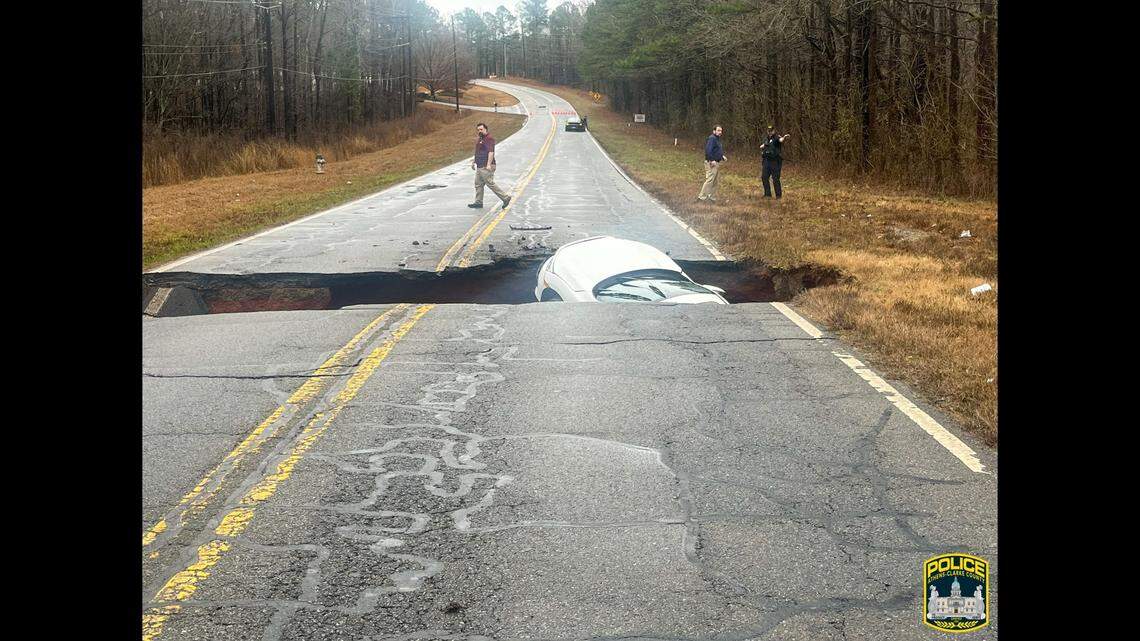 A car driving in Georgia was swallowed by a sinkhole as a result of heavy rain, police said.