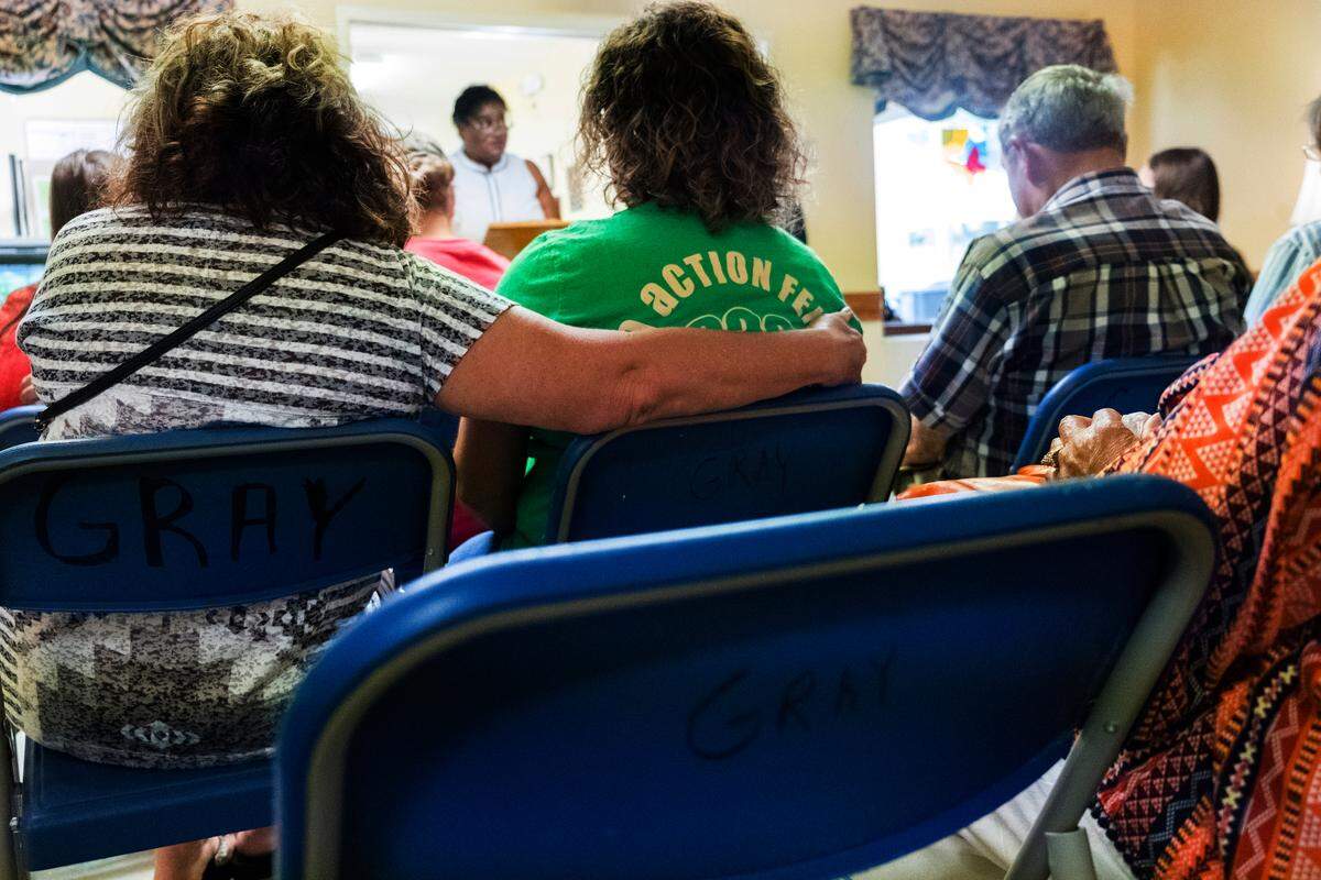 Sylvia McCollough wraps her arm around her daughter, Kim Kohlmayer, while they mourn Sylvia’s father, Melvin Henry “Bo” Daniels, at the annual bereavement ceremony at the Gray Health & Rehabilitation assisted living home on May 14.