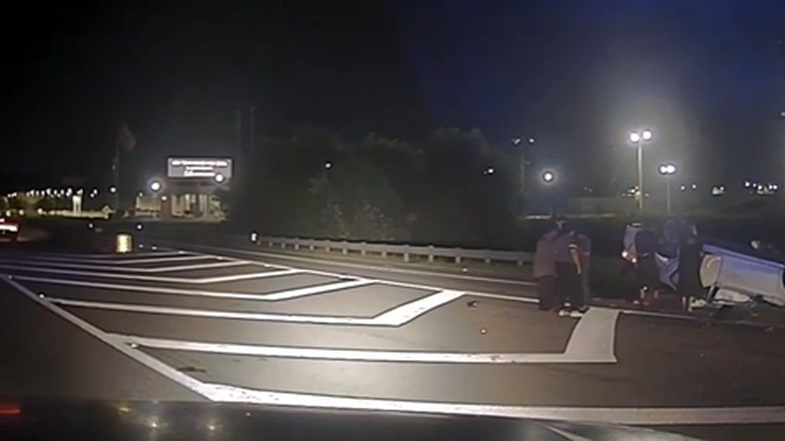 A group raced to free a Georgia driver who got trapped under a flipped car, officers said.