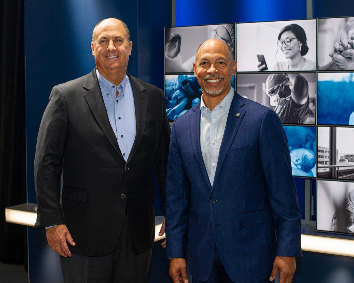 Jim Skogsbergh, president and chief executive officer of Advocate Aurora Health, left, and Eugene A. Woods, Atrium Health president and CEO.