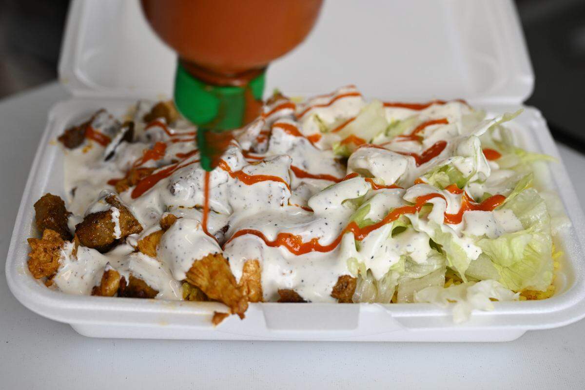 Macon Halal Eats offers authentic halal street food like the Macon lamb and chicken platter shown here.