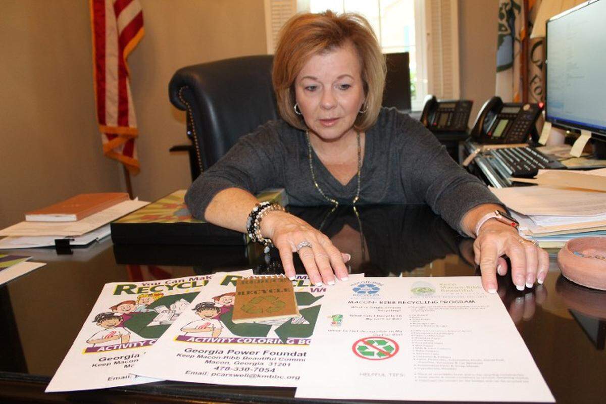 Pam Carswell, president and CEO of the Keep Macon-Bibb Beautiful Commission, shows the materials used in classrooms to educate children about recycling.