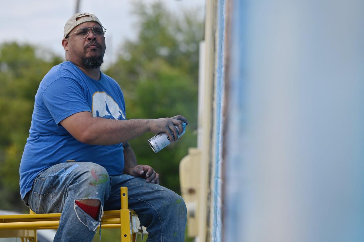 Kevin “Scene” Lewis works on a mural of Rev. Martin Luther King Jr. on Wednesday, Sept. 11, 2024, off of Martin Luther King Jr. Boulevard in Macon, Georgia. The mural will depict King as well as cherry blossoms and Zion Baptist Church, the last place King visited in Macon before his assassination in 1968.