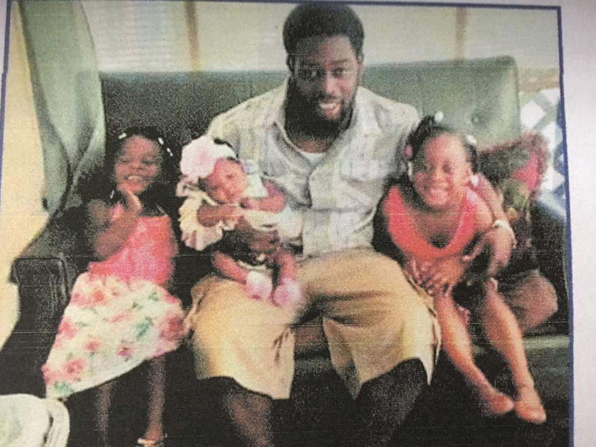 Casey O'Neil Harvey and his children pictured on the back of his funeral program in 2017.
