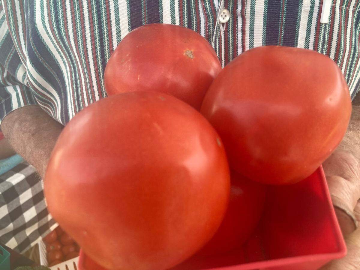 Four fresh-from-the vine, ripe tomatoes from Johnny Abbott of Rust’d Plow Farm at the International City Farmers Market in Warner Robins.