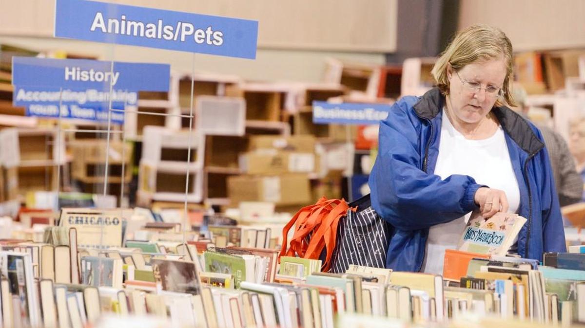 Kristi Morrell, of Ideal, looks through a selection of animal books during the Houston County Friends of the Library Old Book Sale in 2014.