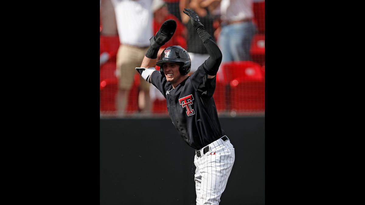 Texas Tech's Gabe Holt celebrates after scoring the final run during an NCAA college baseball tournament super regional game against Duke Saturday in Lubbock, Texas.