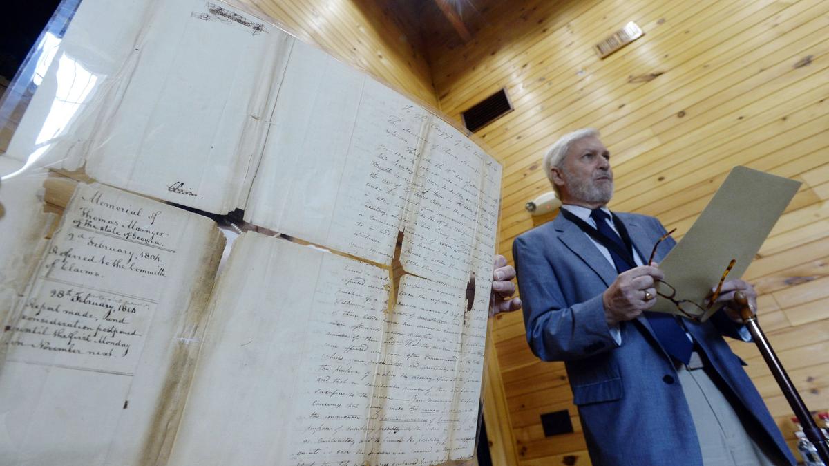 Mercer University history professor Eric Klingelhofer, right, reads the 1804 handwritten letter by military contractor Thomas Maunger to Congress informing them of conditions in Middle Georgia at the time.  Klingelhofer said he received the letter from his father, a collector, and he gave it to Mercer University years later.  It will be on display soon at the Fort Hawkins visitor center.