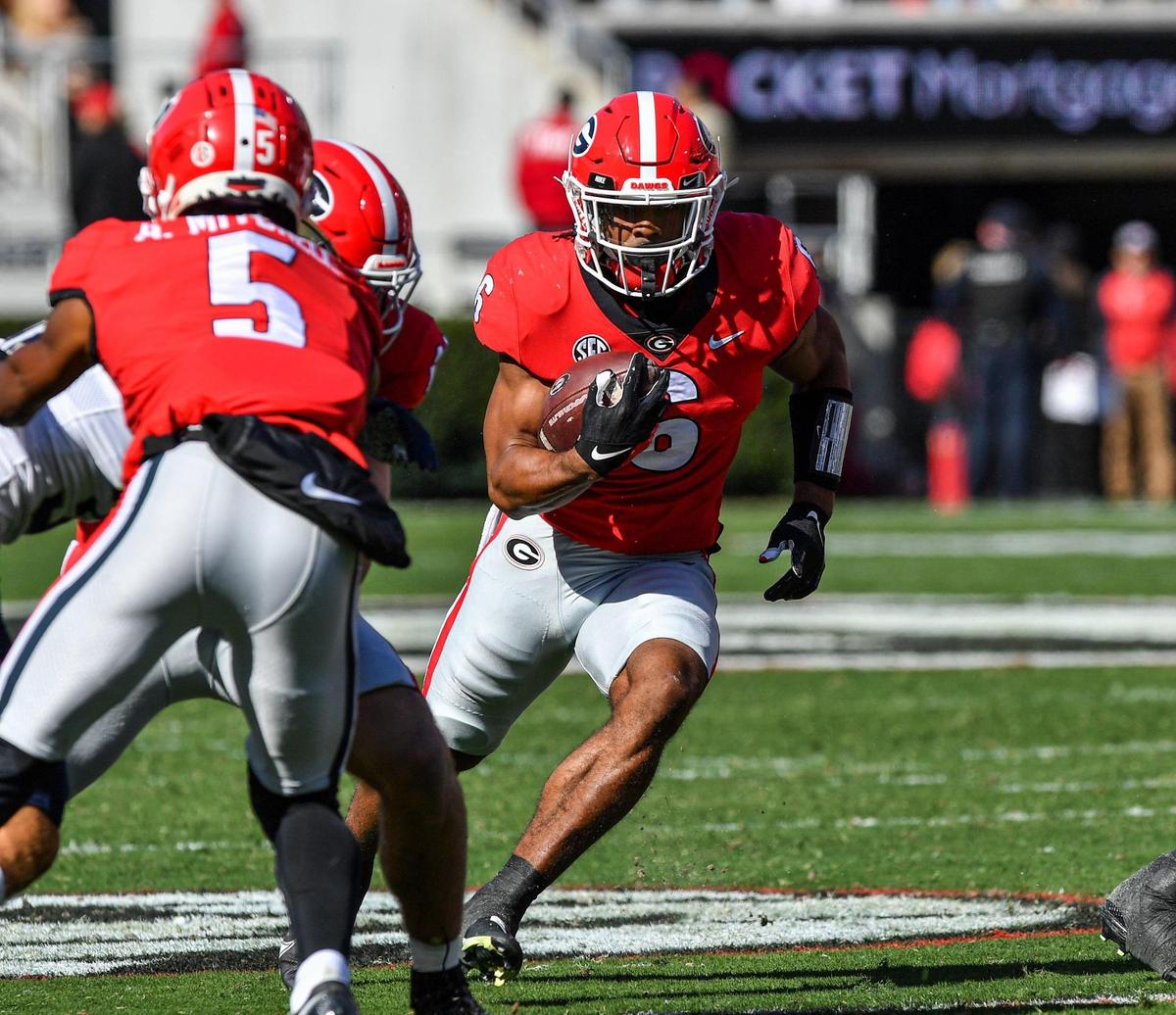 Georgia running back Kenny McIntosh finds a crease in the Charleston Southern defensive line and picks up a Georgia first down in action Saturday in Athens.