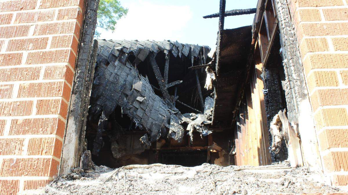 The roof caved into the brick building of Byron United Methodist Church after a man allegedly lit it ablaze on August 20, 2024.