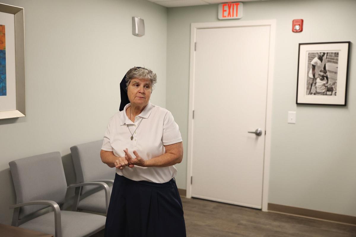 Depaul USA Macon director Sister Theresa Sullivan stops in the waiting room while giving a tour through the Sheridan Health Center waiting room on Tuesday, Sept. 10, 2024, in Macon, Georgia. The newly opened center is operated by Depaul USA and offers both a clinic and medical respite for people without insurance experiencing homelessness.