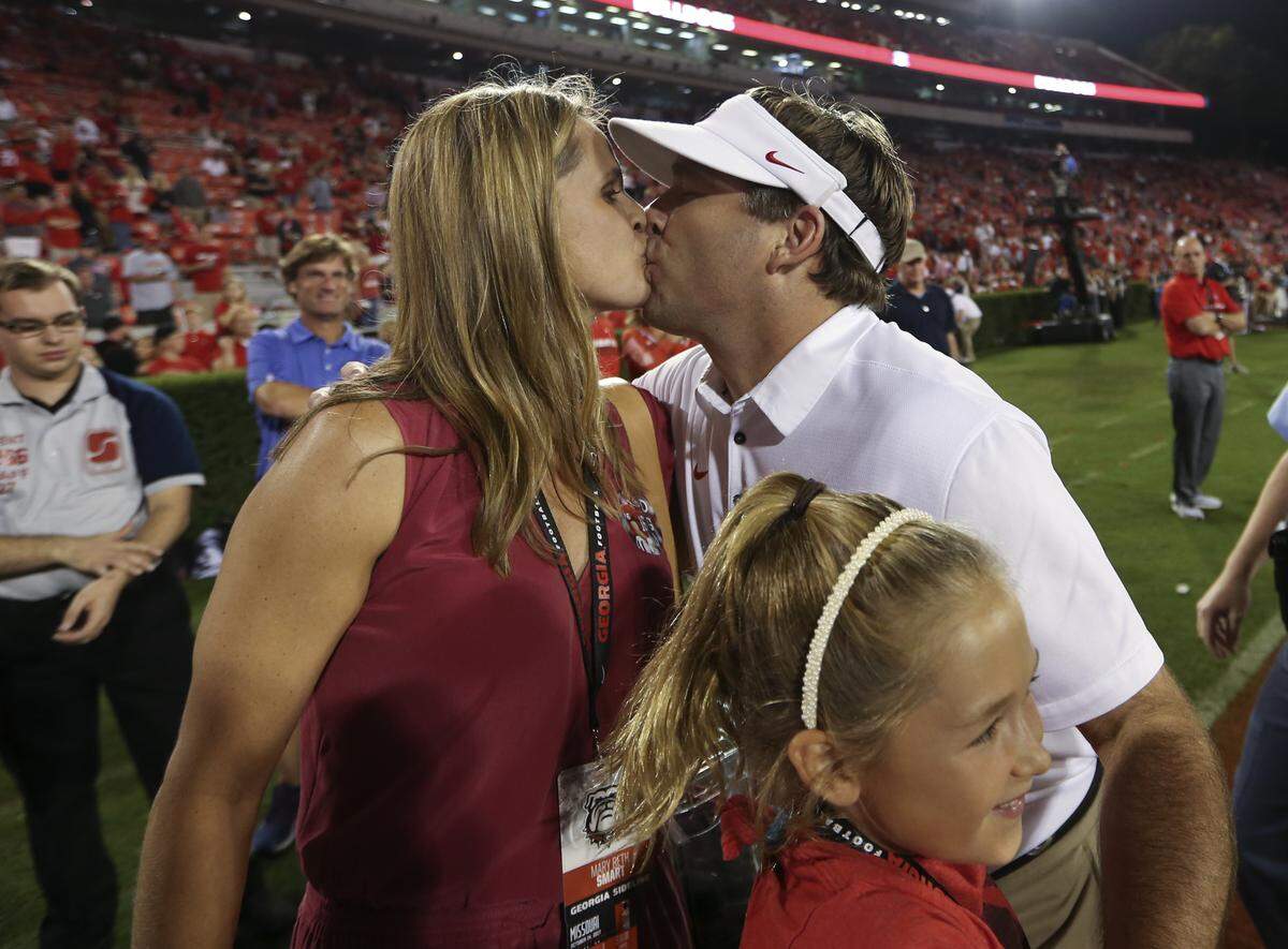 Georgia coach Kirby Smart kisses his wife, Mary Beth, next to daughter Julia after Georgia defeated Missouri 53-28 in an NCAA college football game Saturday, Oct. 14, 2017, in Athens, Ga.