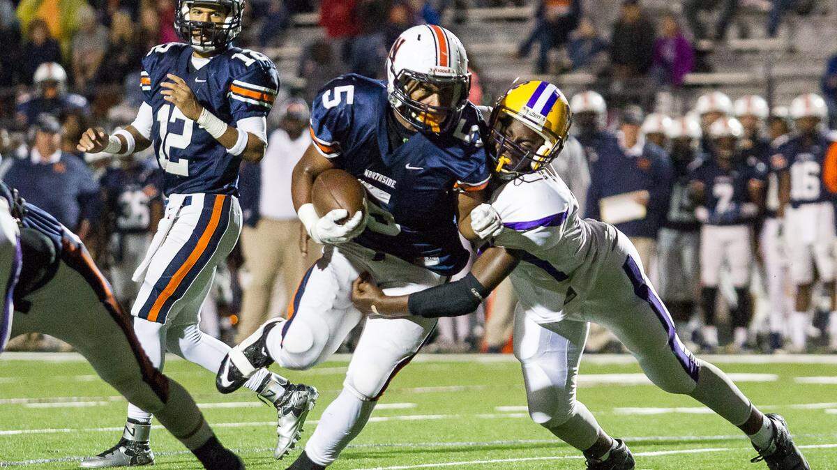 Northside's Desean Dinkins runs up the middle in the first half of their 2-AAAAA matchup against Richmond Academy.
