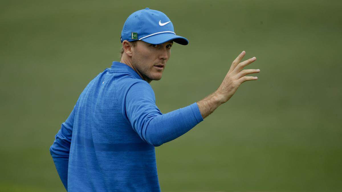 Russell Henley waves after his birdie on the second hole during the third round at the Masters golf tournament.