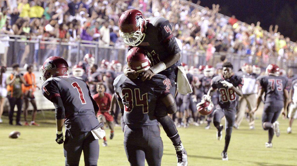 JASON VORHEES/THE TELEGRAPH Macon, GA, 09/04/2015: 
 Howard running back JaQwun Stinson (34) celebrates with quarterback Courvoisier King (4) after catching a two-point conversion in the final minute of their win over Central Friday night.