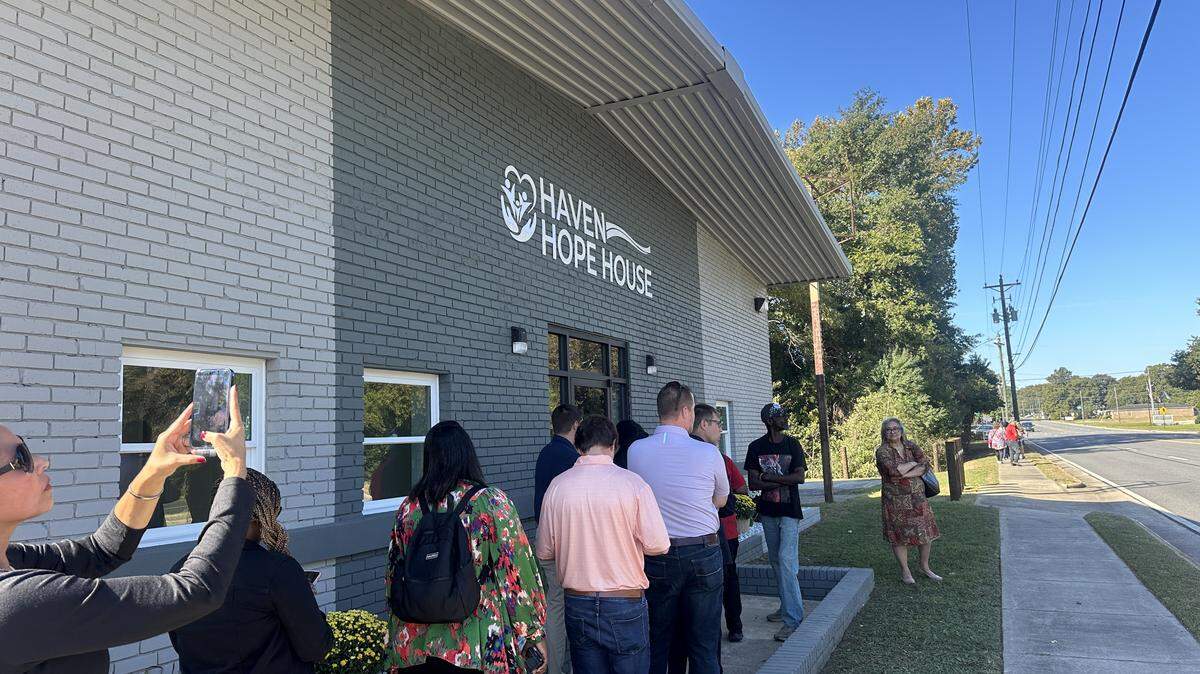 People line up outside Haven Hope House during its grand opening on October 17, 2025, in Warner Robins, Georgia. Haven Hope House is Warner Robins’ first city-sponsored homeless shelter.