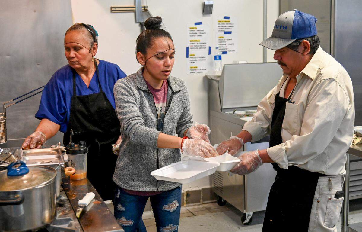 Brenda Torres prepares food in the kitchen with her mother Lorenza Torres and father Jose Hernandez at El Sazon Homestyle Mexican Food in Macon.