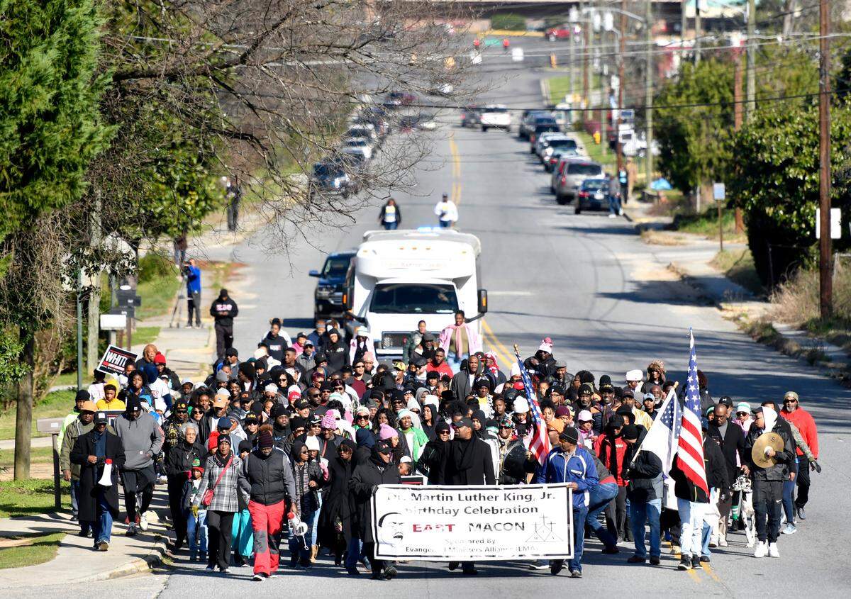 JASON VORHEES/THE TELEGRAPH Macon, GA, 01/20/2020: Marchers walk along Maynard Street in East Macon Monday on their way to the Macon-Bibb Government Center during the annual MLK Memorial March. Marchers started from the Rosa Jackson Center, Booker T. Washington Center, Frank Johnson Center and Memorial Gym.