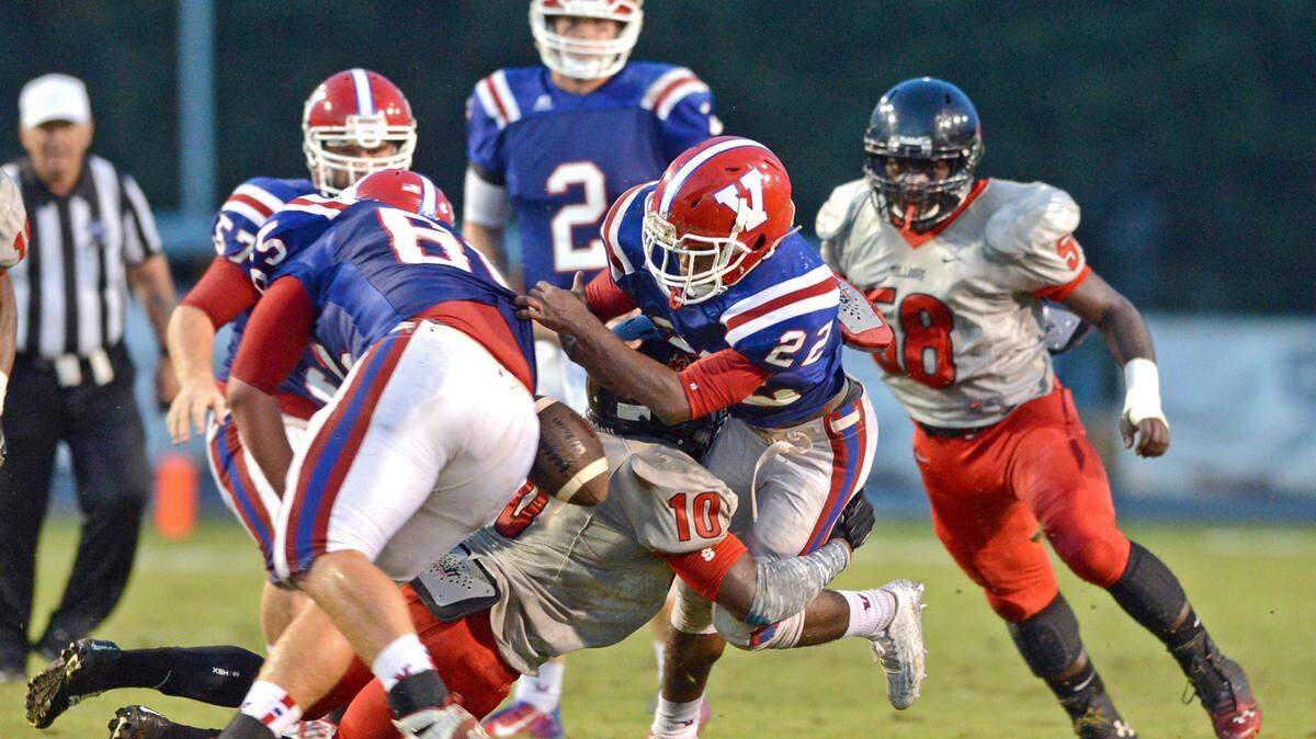 Photo by Danny Gilleland For The Telegraph 09/04/15 
 Perry, Ga Macon County's Kentarius Felton hits Venerans Desjuan Harris and knocks the ball loose. Veterans got the ball back.