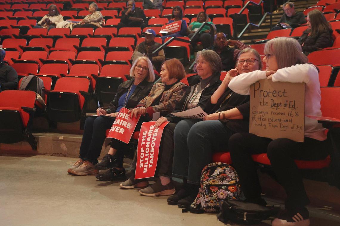 Town hall attendees sit with posters before the start of the town hall hosted by the local chapter of the American Federation of Government Employees (AFGE) on Thursday, March 20, 2025, at the Homer J. Walker Civic Center in Warner Robins, Georgia. Rep. Sanford Bishop (D-GA) spoke to constituents’ concerns about cutting federal programs and policies from President Donald Trump. AFGE also invited Rep. Austin Scott (R-GA), who did not attend.
