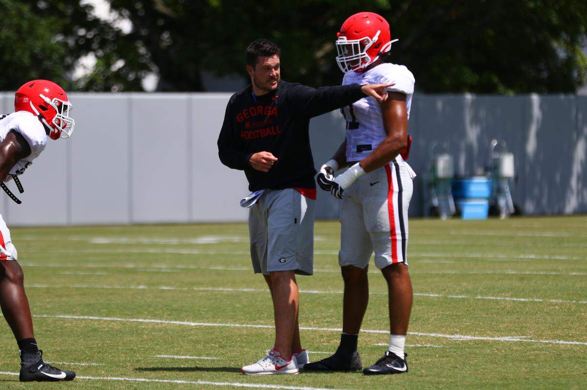 Fain and Billy Slaughter Defensive Coordinator and outside linebackers coach Dan Lanning instructs Georgia linebacker Jermaine Johnson (11) during the Bulldogs’ session on the Woodruff Practice Fields in Athens, Ga., on Thursday, Aug. 8, 2019.